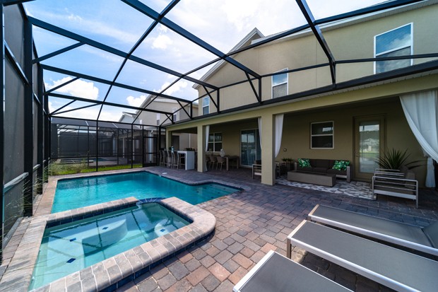 Outdoor area with a private covered pool at Hulk home in Orlando